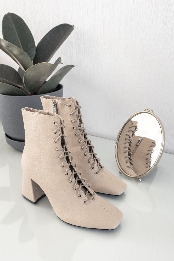 lace-up suede boots and a plant