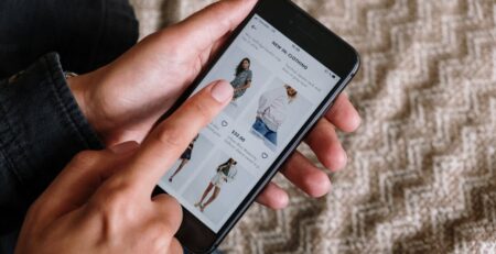 A person holding a phone to order clothes online