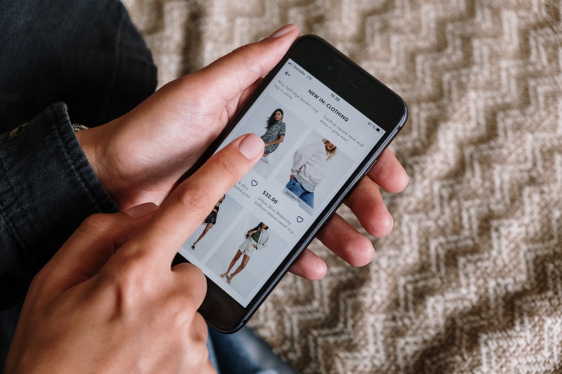 A person holding a phone to order clothes online