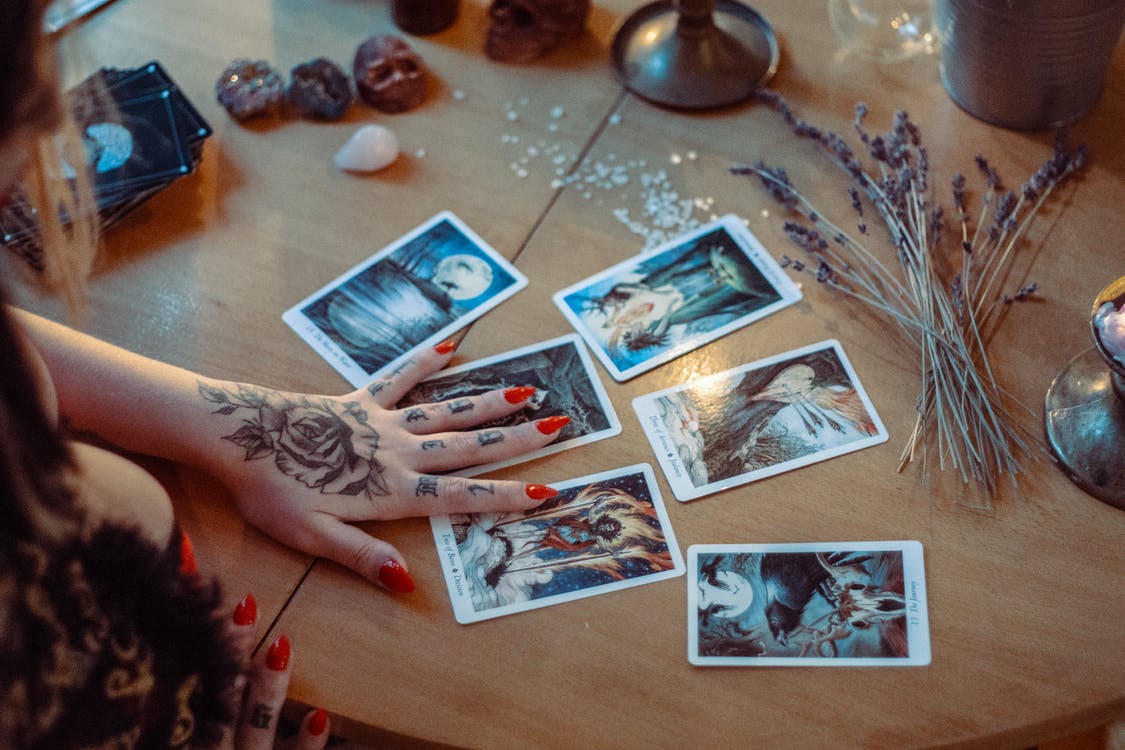A woman’s hand on tarot cards