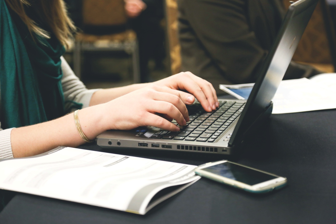 A person writing on their laptop