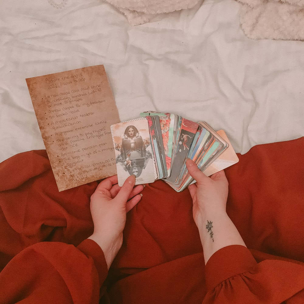 A woman holding tarot cards 