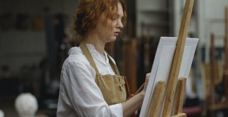 A woman drawing on paper on an easel