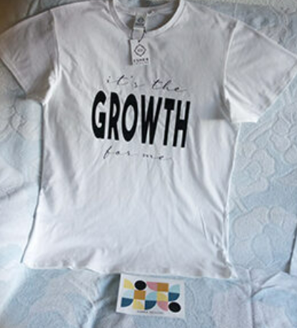 A white t-shirt with the phrase "It's the growth for me" on it
