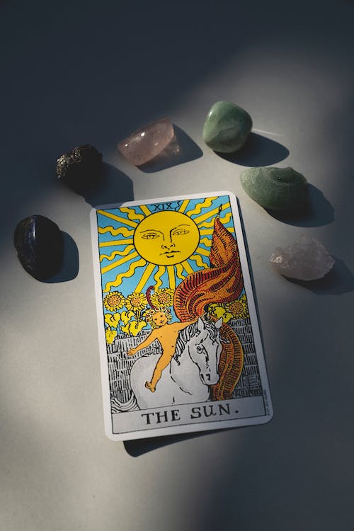 Tarot card surrounded with pebbles