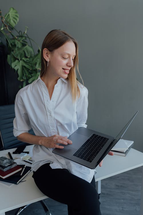 A woman wearing a white button-down shirt 